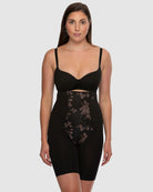 Woman wearing a black shapewear garment on a white background