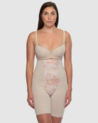 Woman wearing a beige shapewear garment on a white background