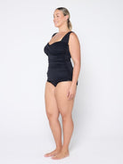 Woman wearing a black swimsuit on a white background
