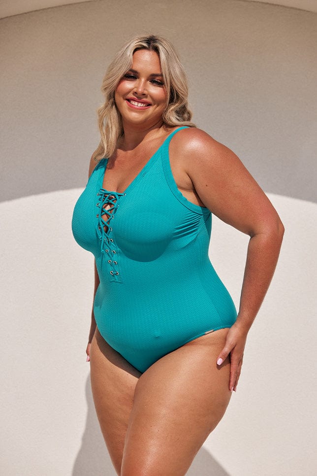 blonde plus size model wears aqua blue tie up one piece