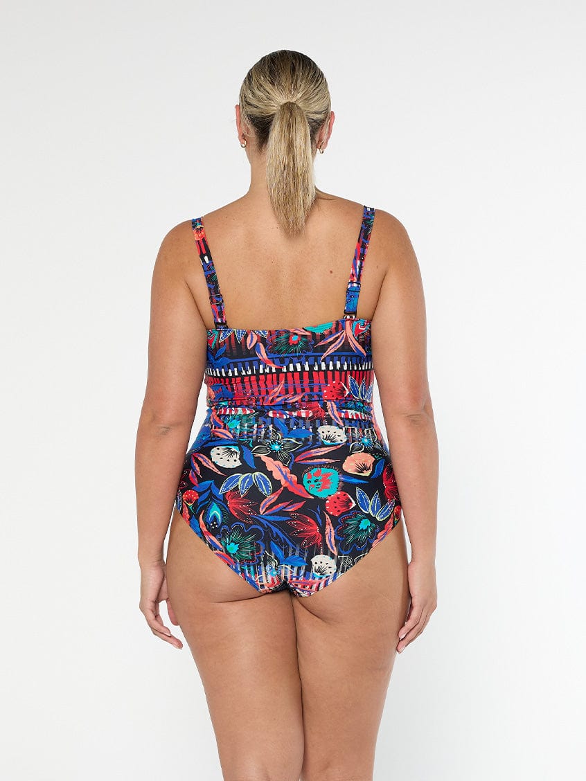 Back of model wearing a multi coloured print with florals with adjustable straps