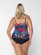 Back of model wearing tankini top with multi coloured pattern on it with adjustable and removable straps