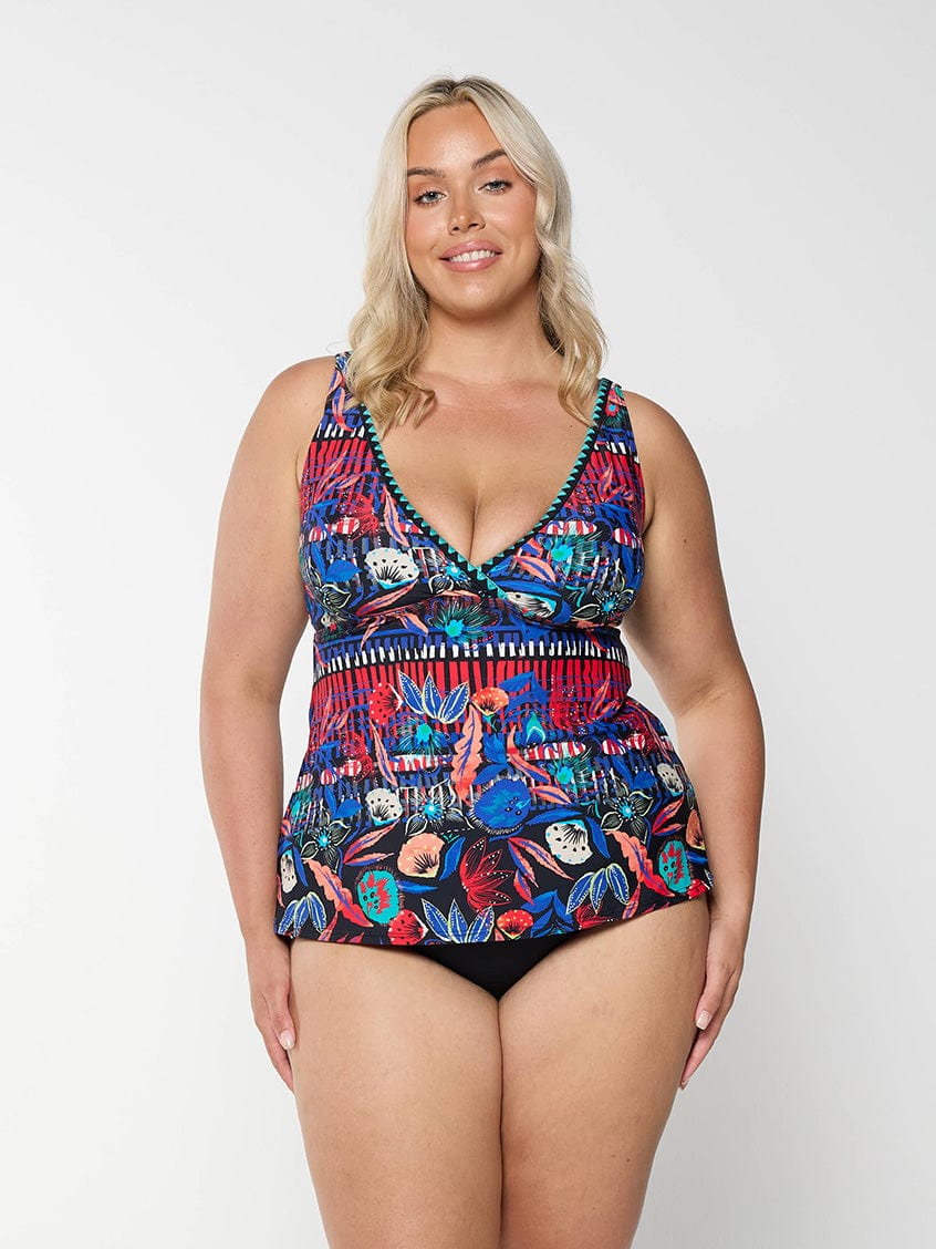 Front of curve model in studio wearing a multi coloured tankini top with v neckline