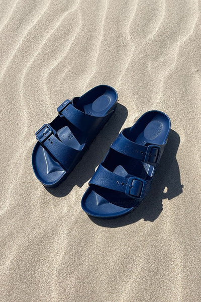 Navy birkenstock eva sandals on the beach for curve women