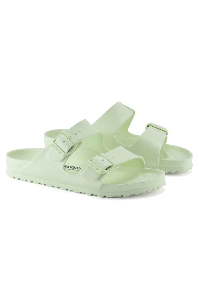 faded lime green slide on sandals with buckle detail