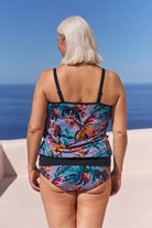 Back of model with white hair wearing flattering swim pant for curve women