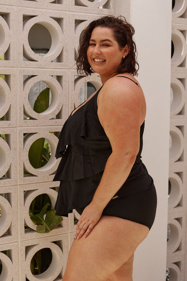 plus size model wears chlorine resistant black 3 tier tankini top