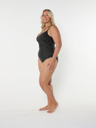 Woman wearing a black swimsuit on a white background