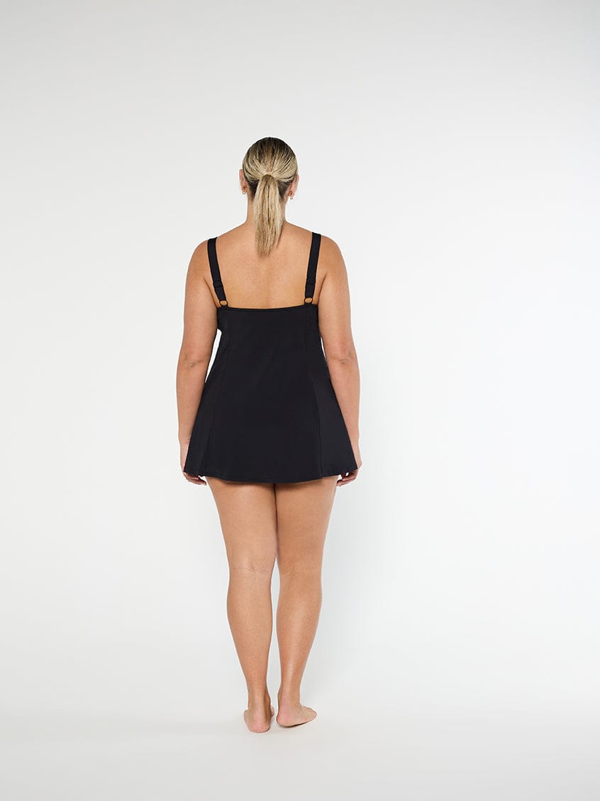 Person wearing a black swimsuit on a white background