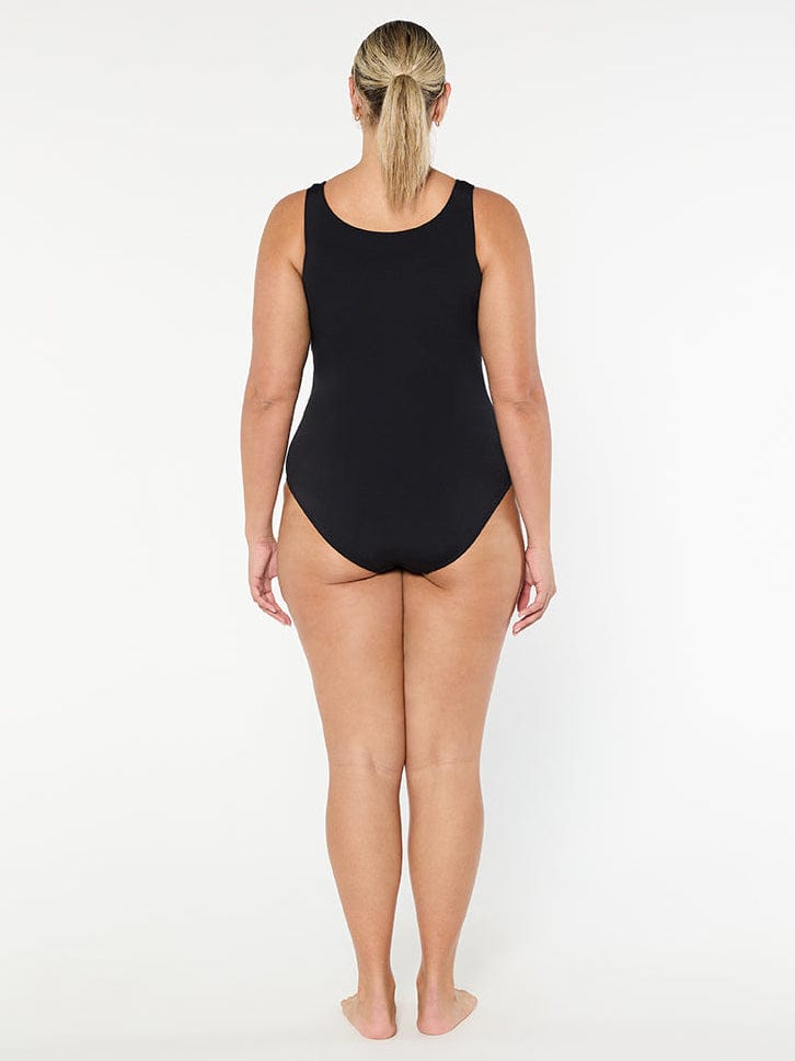 Person wearing a black swimsuit on a white background