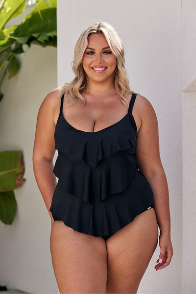 Blonde model wearing black 3 tier one piece