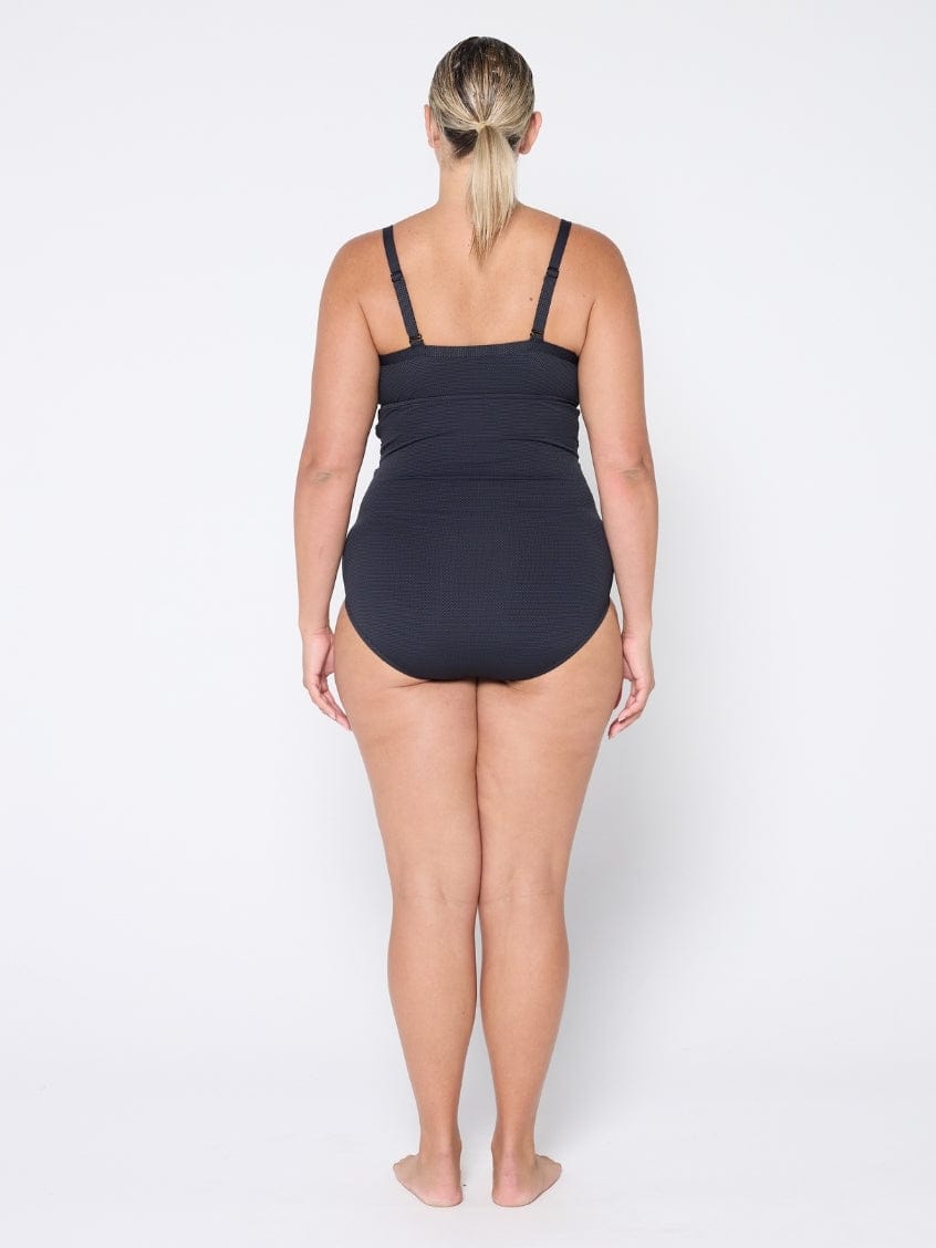 Woman wearing a black swimsuit on a white background