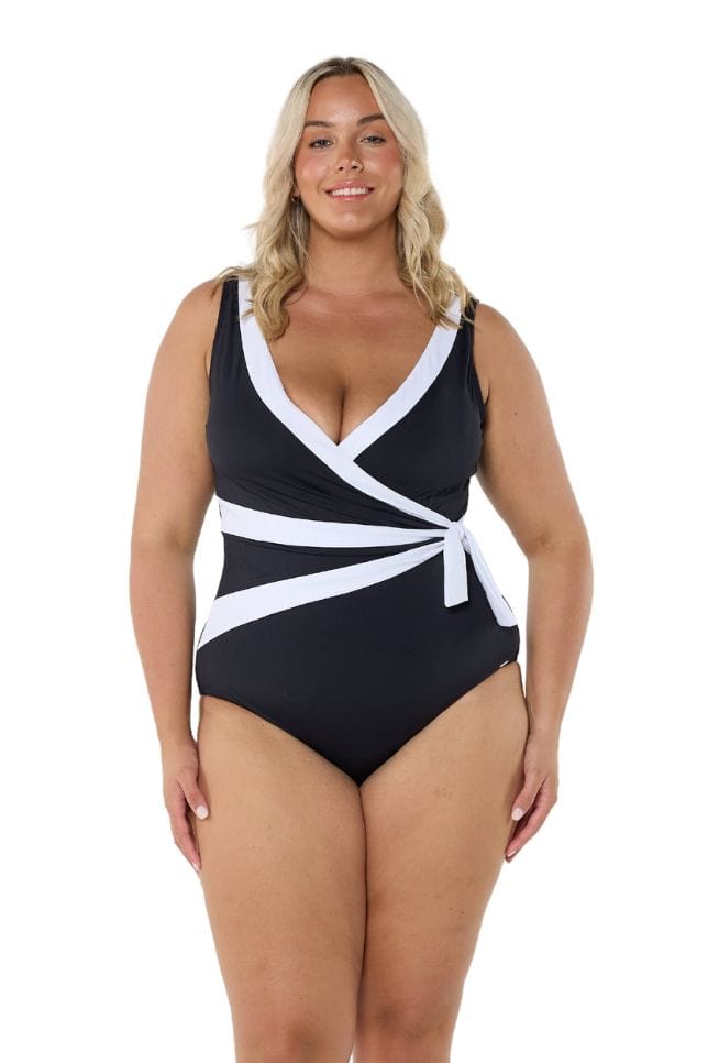 Model wearing black and white waist tie one piece