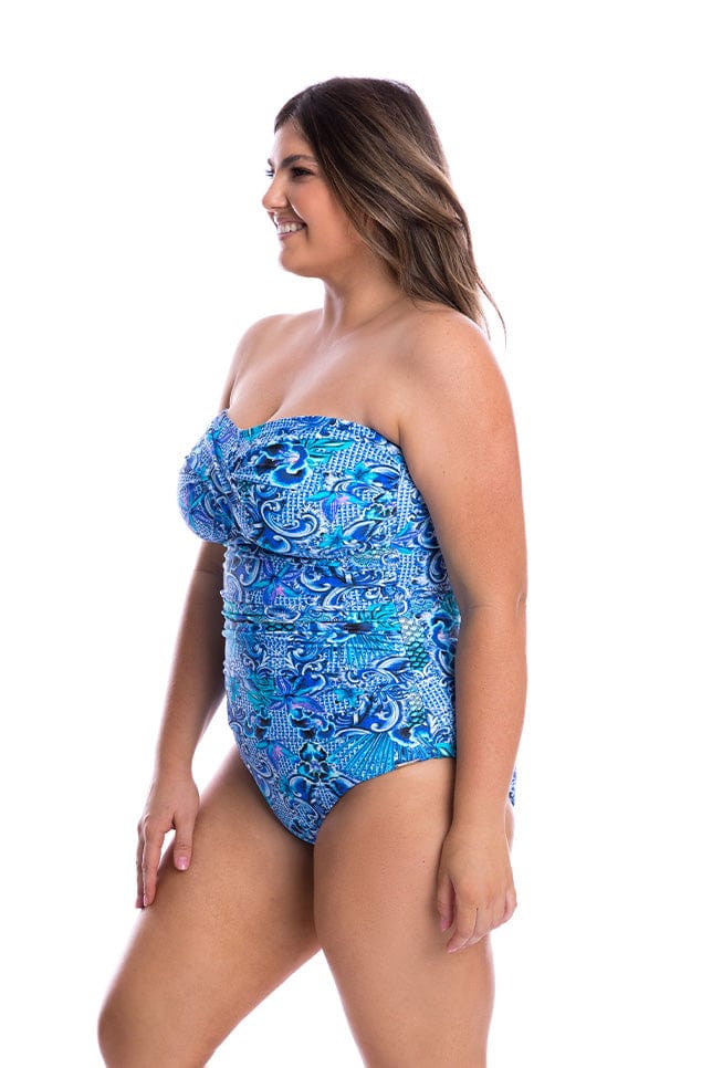 Model showing side of blue bandeau one piece swimsuit