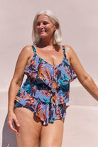 Model wearing tropical print 3 tier tankini top