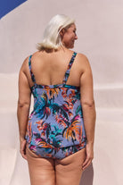 Back of model wearing tankini swim top in blue floral print for curve women