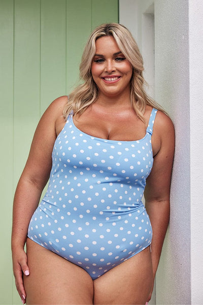 Blonde model wearing baby blue spotty one piece