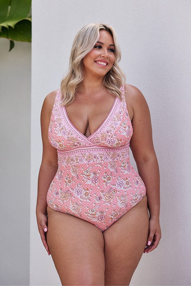 Blonde model wearing light pink floral v neck one piece