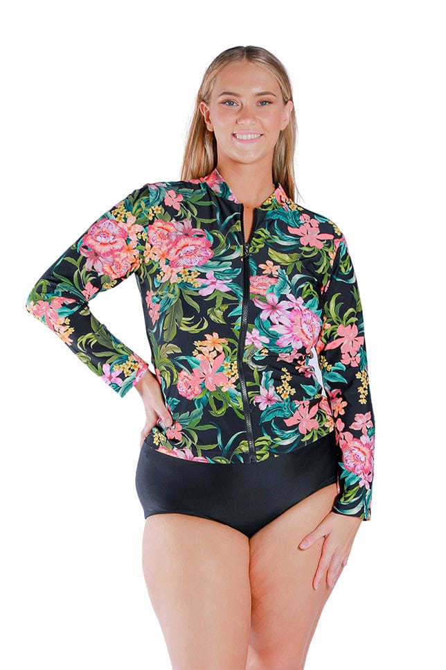 Model wearing floral and black printed long sleeved rash vest with zip front 