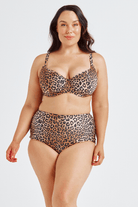 Woman wearing a leopard print bikini set on a white background