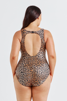 Woman wearing a leopard print swimsuit on a white background