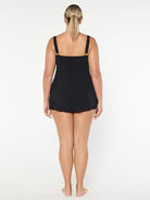 Person wearing a black swimsuit on a white background