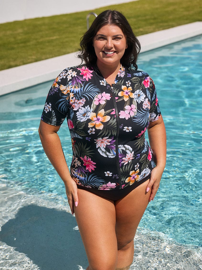 Woman wearing a floral swimsuit by a pool