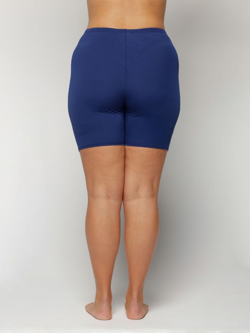 Person wearing blue swim shorts chlorine resistant on a plain background