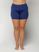 Curve women wearing navy chlorine resistant on a plain background