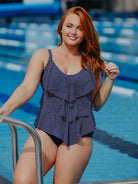 Woman in a polka dot swimsuit standing by a pool