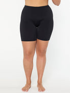 Person wearing black shorts on a white background