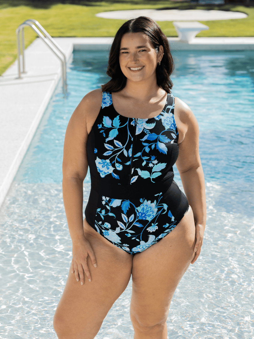Woman wearing a zip front one piece chlorine resistant in blue and black