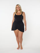 Woman wearing a black sleeveless dress on a white background