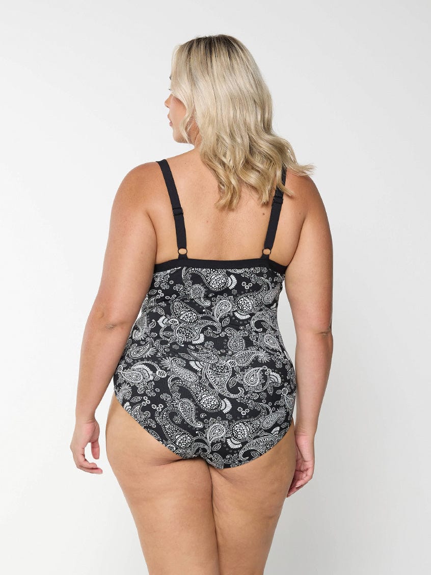 Back of model wearing a plus size tankini top with underwire support in a paisley print with adjustable straps.