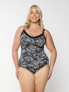 Blonde woman wearing plus size underwire tankini top with black and white paisley print