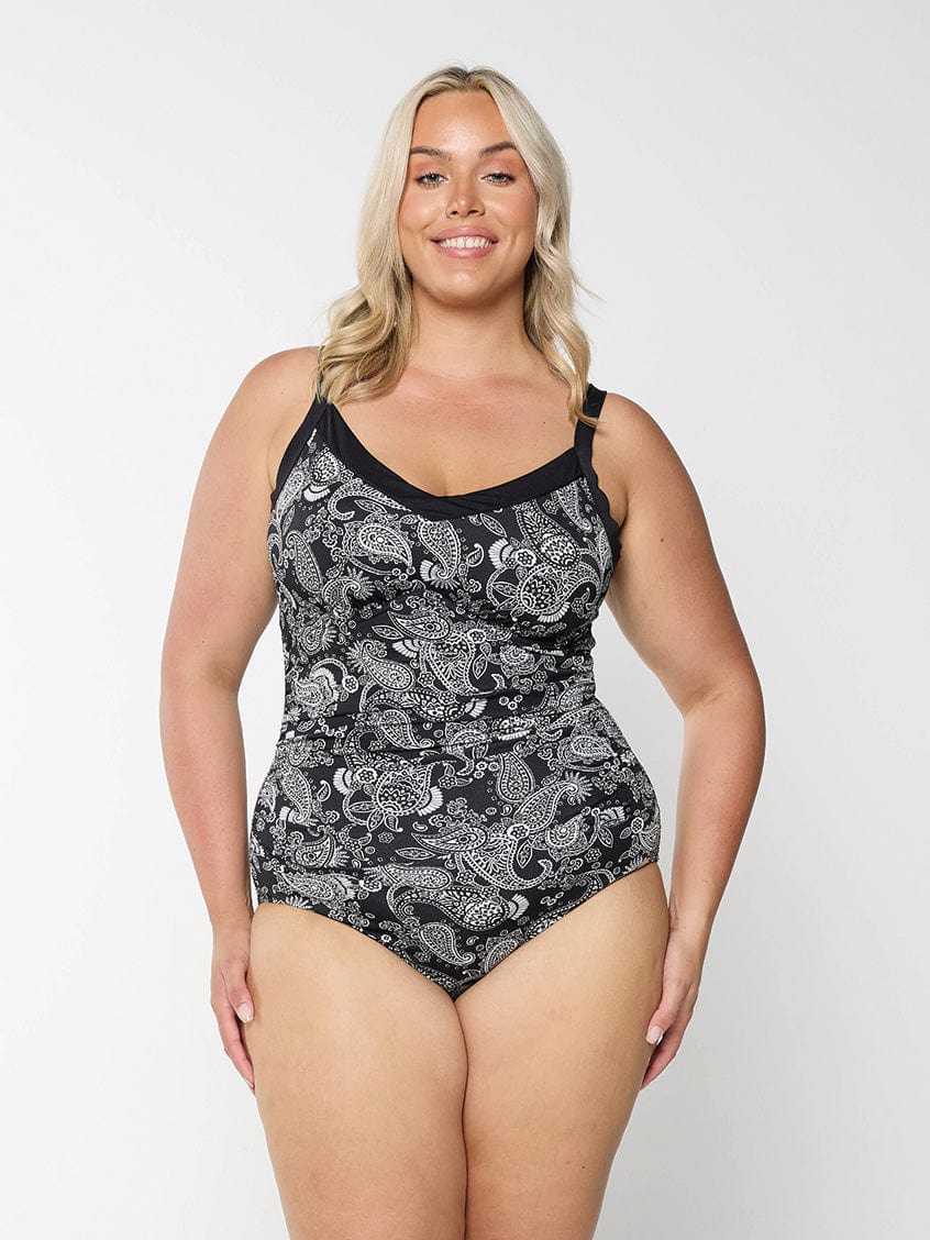 Blonde woman wearing plus size underwire tankini top with black and white paisley print