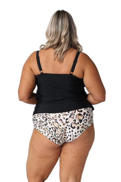 Blonde model in studio wearing black ruffled tankini top for plus size women
