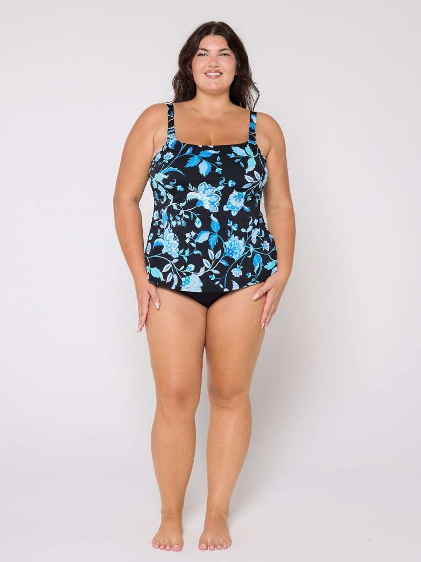 Woman wearing a floral-patterned tankini on a white background