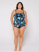 Woman wearing a floral-patterned tankini on a white background