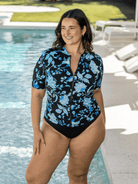 Woman wearing a chlorine resistant rash vest in turquoise blue and black