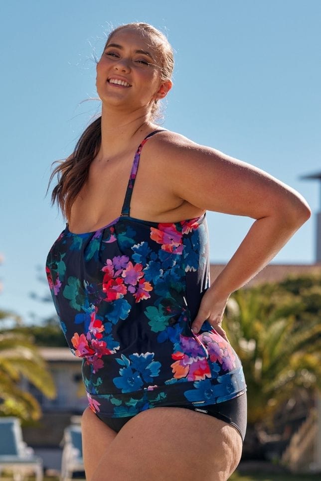 Curve model wearing large bust flouncy tankini in navy floral print Australia