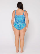 Woman wearing a blue patterned swimsuit on a white background