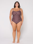 Woman wearing a polka dot swimsuit on a white background