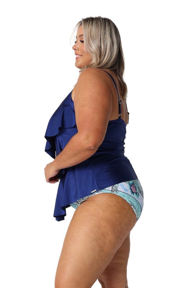 Side of blonde model in studio wearing three tiered tankini top in metallic navy colour