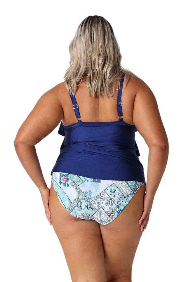 In studio model wearing ruffle tankini top for curvy women with adjustable straps