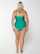Woman wearing a green swimsuit on a white background