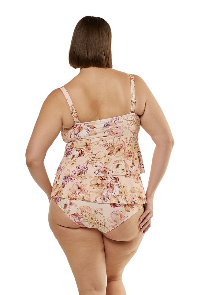Plus size brunette model wearing pink floral bandeau top with removable straps