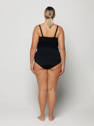Woman against a plain background