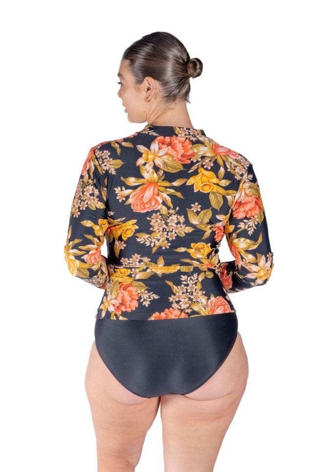 Back of curve model wearing zip front rash swim top in floral print Australia