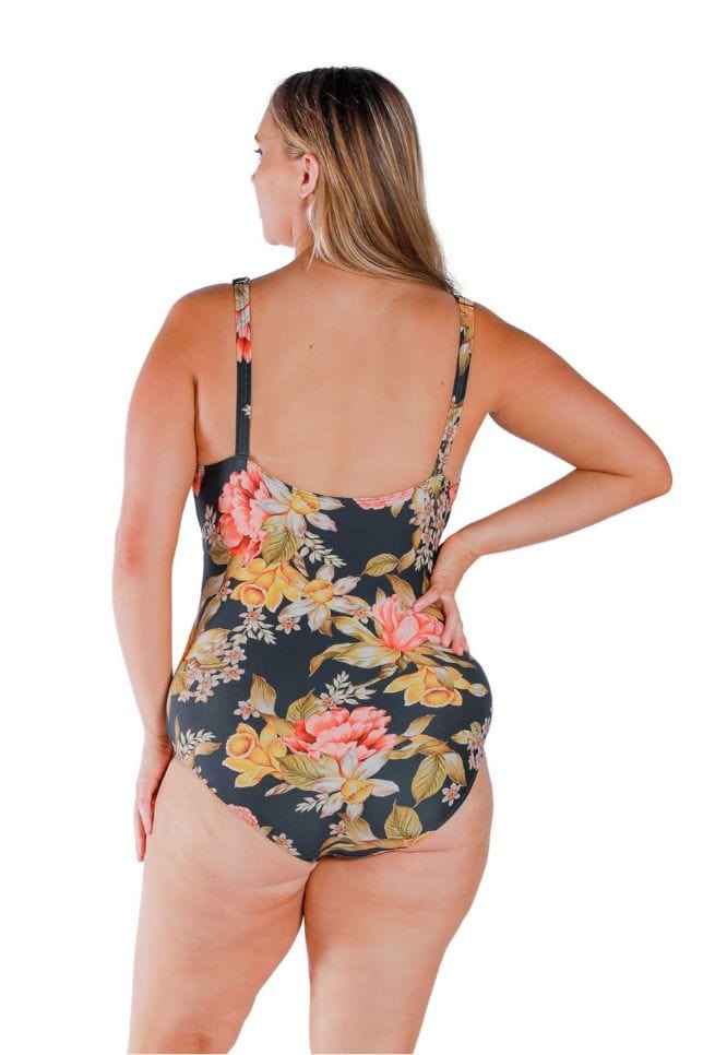 Back of model wearing flattering one piece with adjustable straps for curvy women in orange red and yellowfloral print